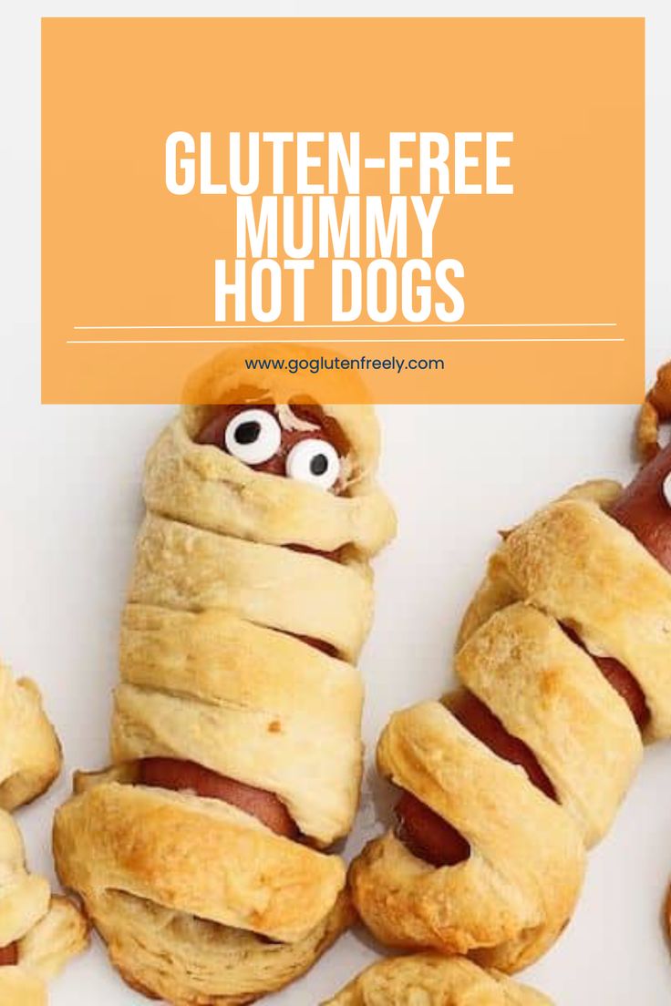 hot dogs wrapped in dough with googly eyes and mouth on them, sitting next to the words gluten - free mummy hot dogs