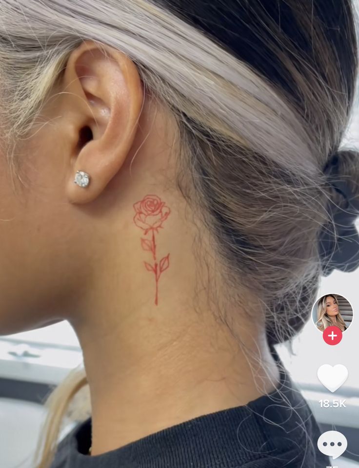 a woman with a rose tattoo on her left side behind her ear and the other half of her neck