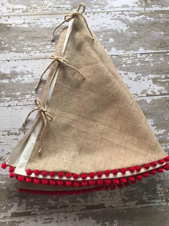 a red and white pin cushion sitting on top of a wooden floor