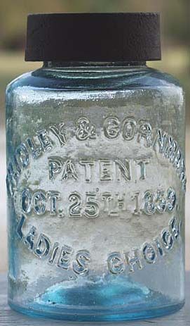 a blue glass jar sitting on top of a wooden table