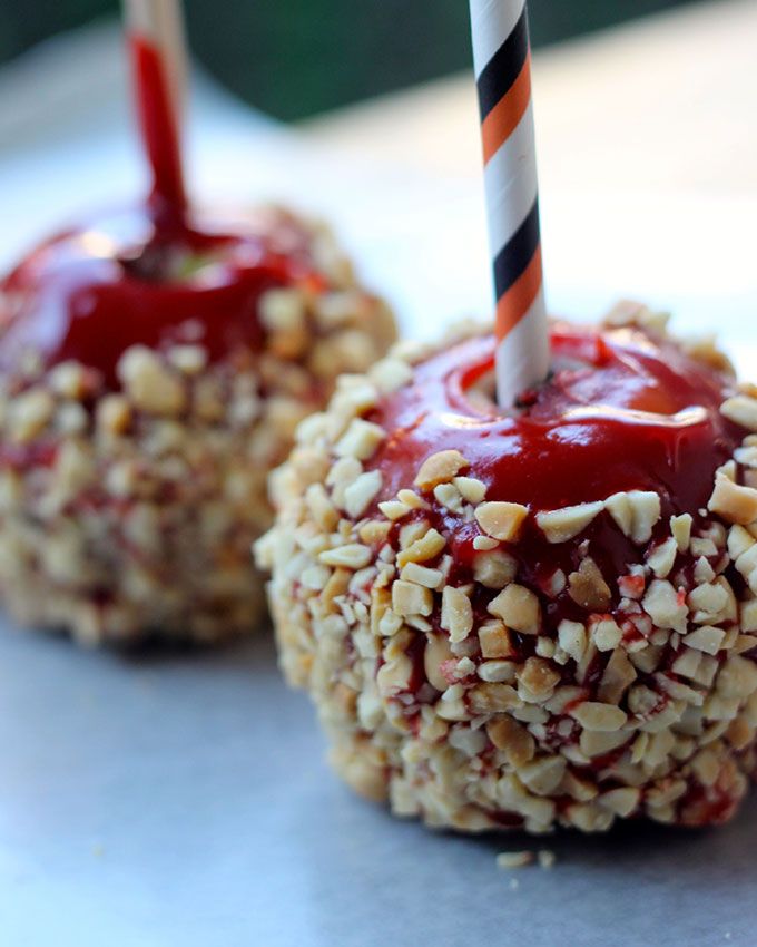 two desserts with strawberries and nuts on them, one has a candle in it