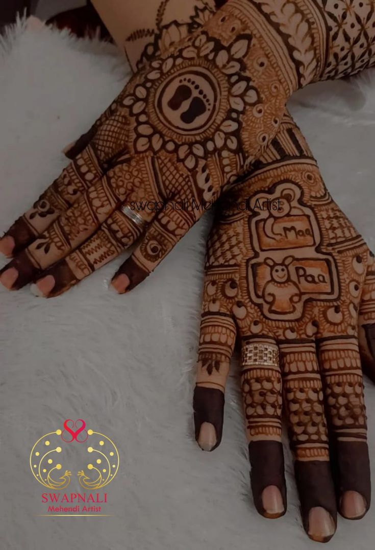 the hands and feet of a woman with henna tattoos