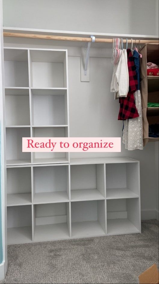 an organized closet with shelves and clothes hanging on the wall, next to a sign that reads ready to organize