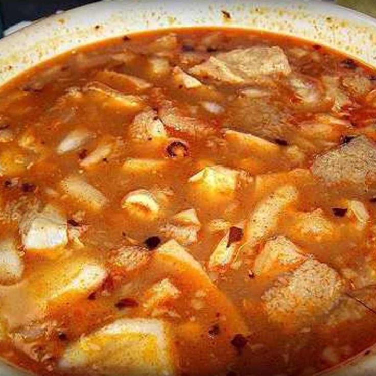 a white bowl filled with soup on top of a table