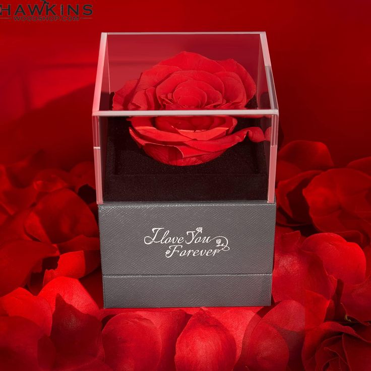 a red rose is in a clear box with the words i love you forever on it