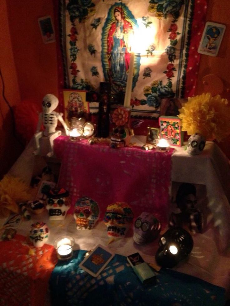 an altar with candles and pictures on it