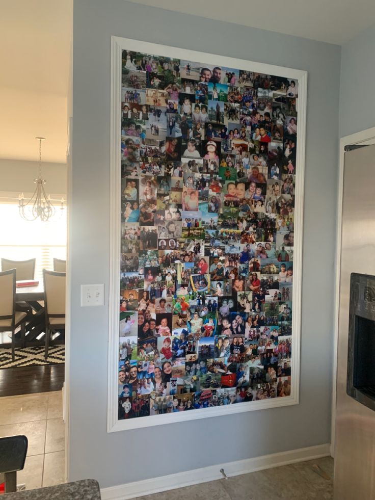 a large poster is hanging on the wall next to an oven and microwave in a kitchen