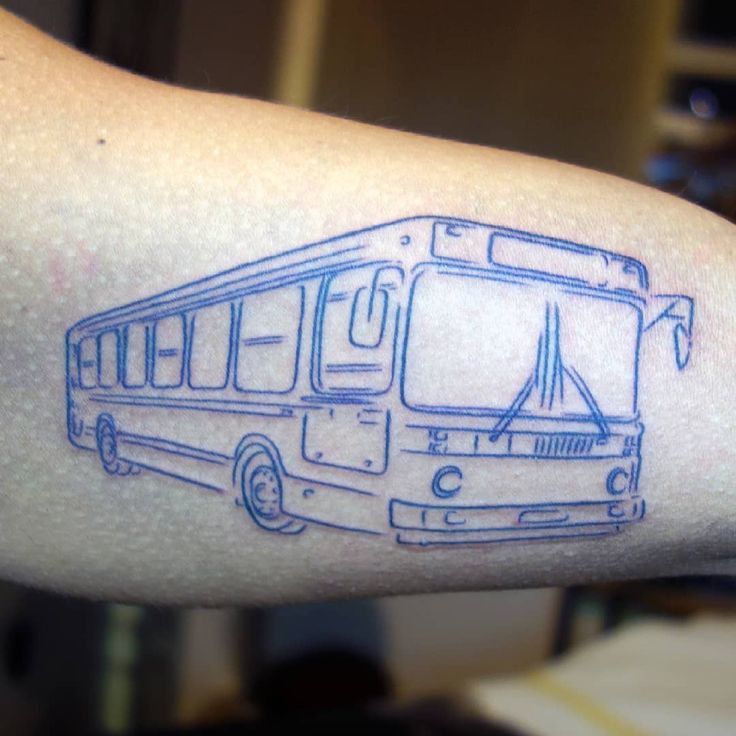 a blue bus tattoo on the arm