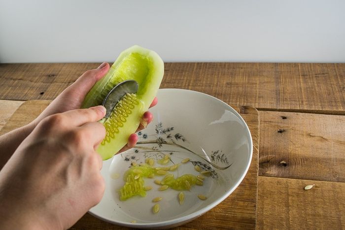 a person is peeling an apple into small pieces