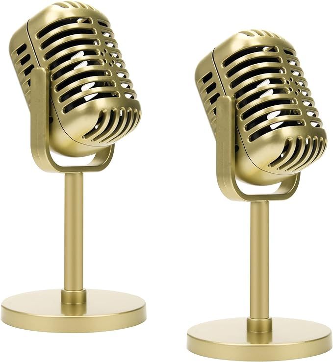 two gold colored microphones on stand against a white background