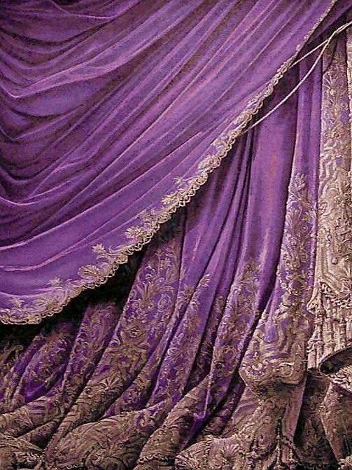 an image of a bed with purple drapes on it