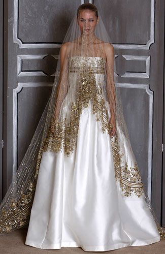 a woman standing in front of a door wearing a wedding dress with gold sequins on it