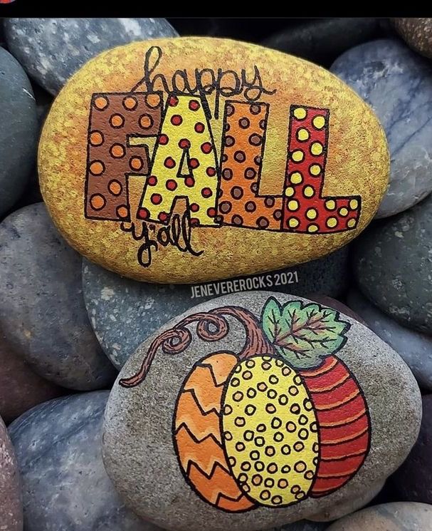 two rocks that have been painted to look like pumpkins and the words fall on them