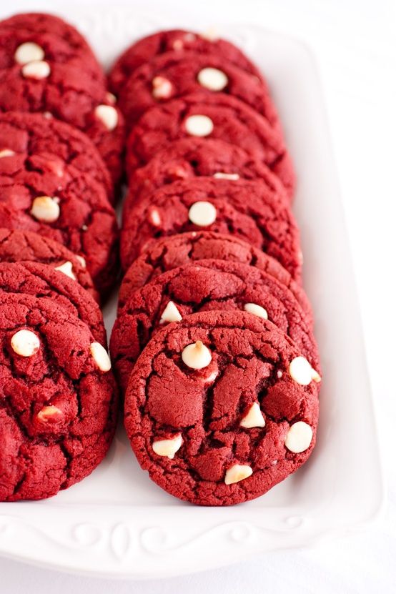 red cookies with white chocolate chips are on a plate