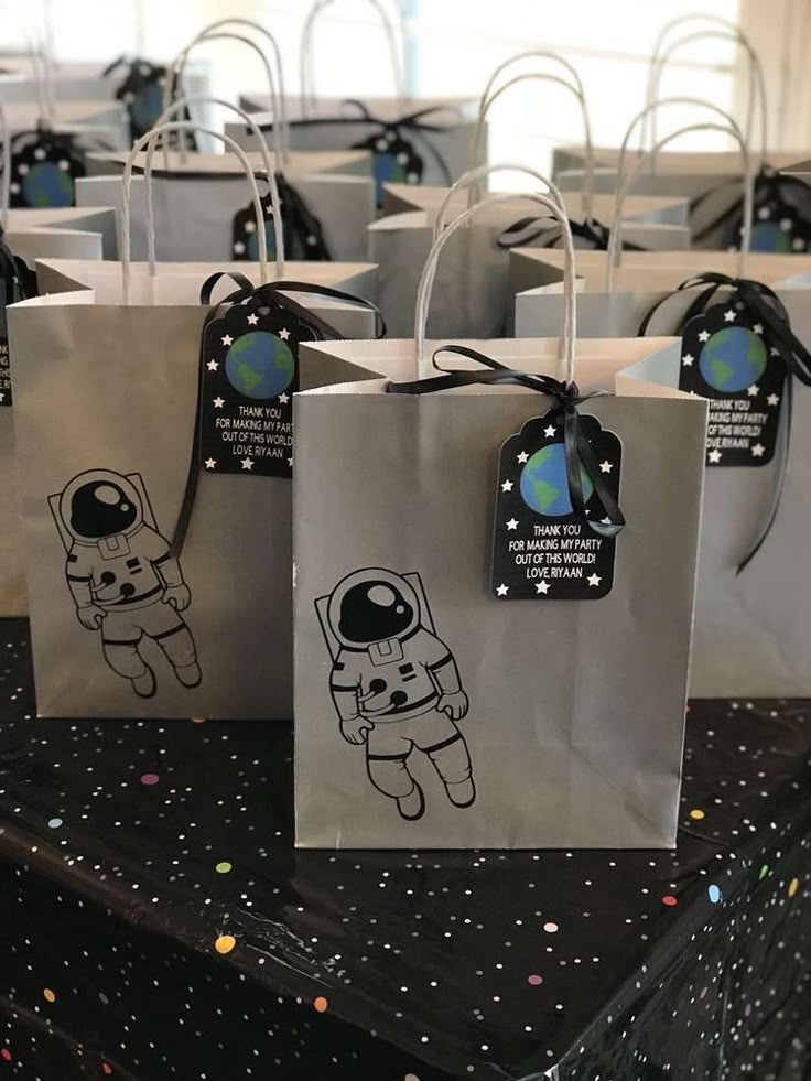 small bags with stickers on them sitting on top of a black and white table