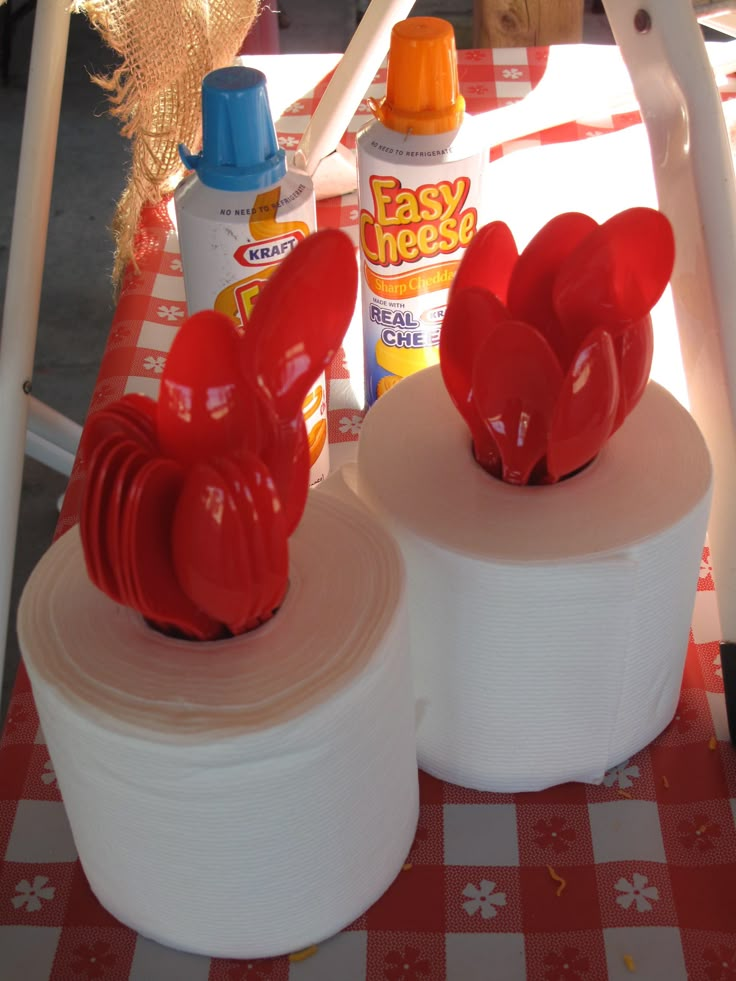 there are two red hearts on top of rolls of toilet paper