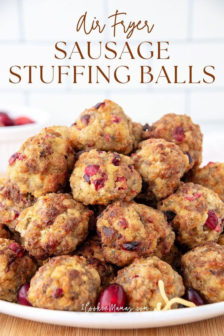 a white plate filled with cranberry sausage stuffing balls on top of a wooden table