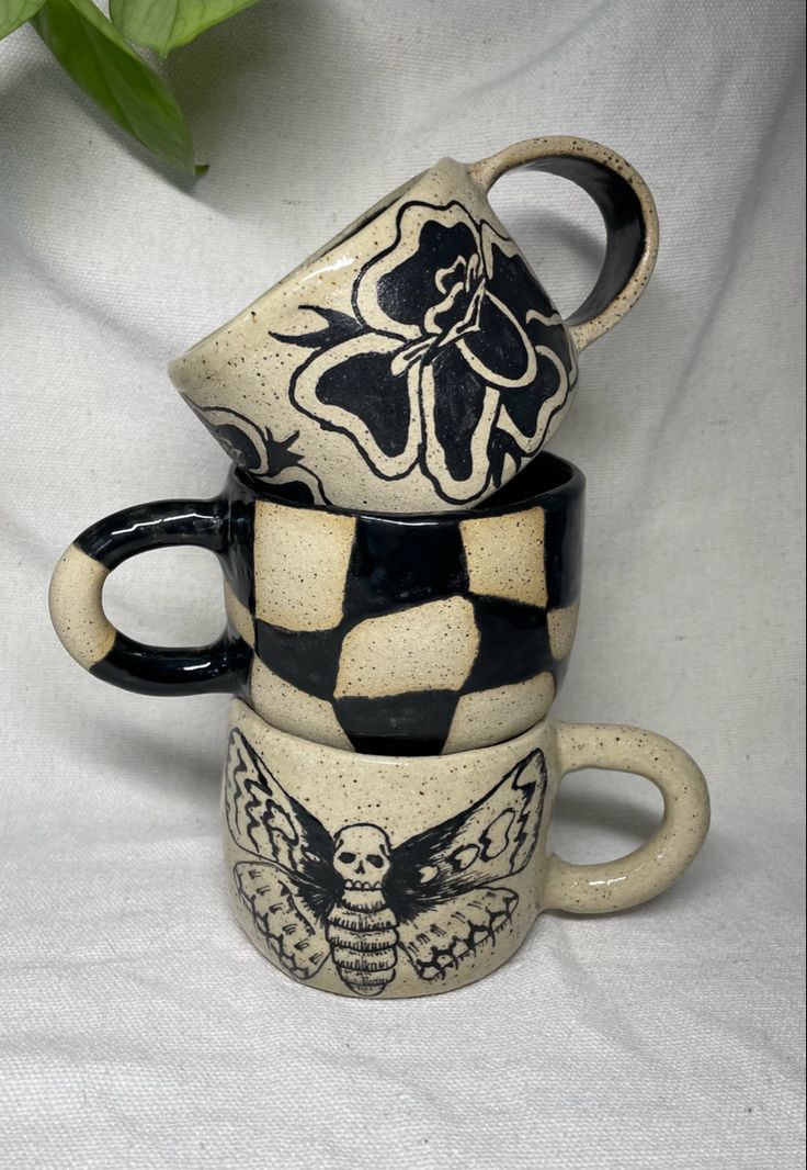 three coffee mugs stacked on top of each other with an owl and flower design