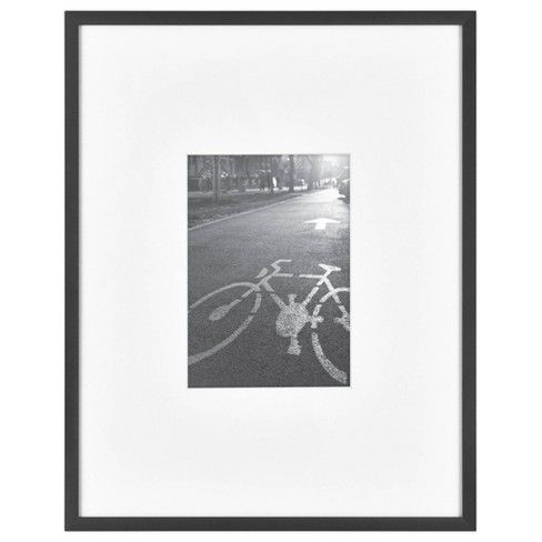 a black and white photo of a bicycle on the road