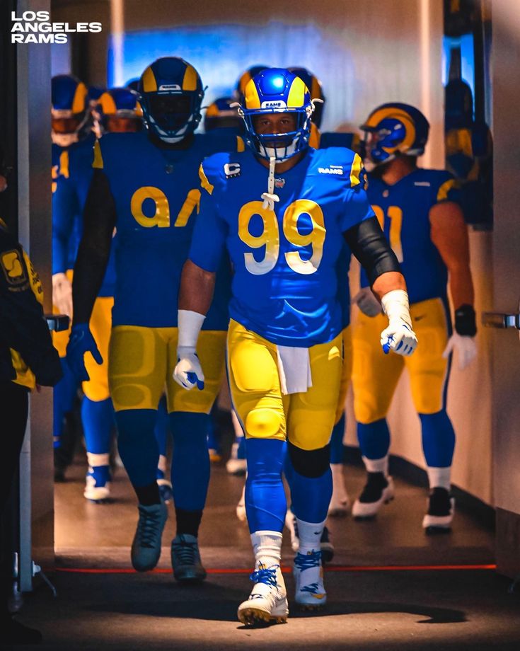 the los angeles rams football team is walking down the hallway