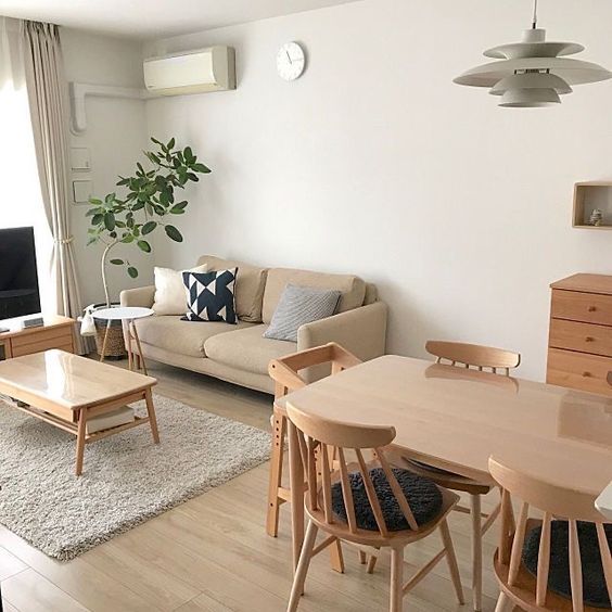 a living room filled with furniture and a flat screen tv sitting on top of a wooden table