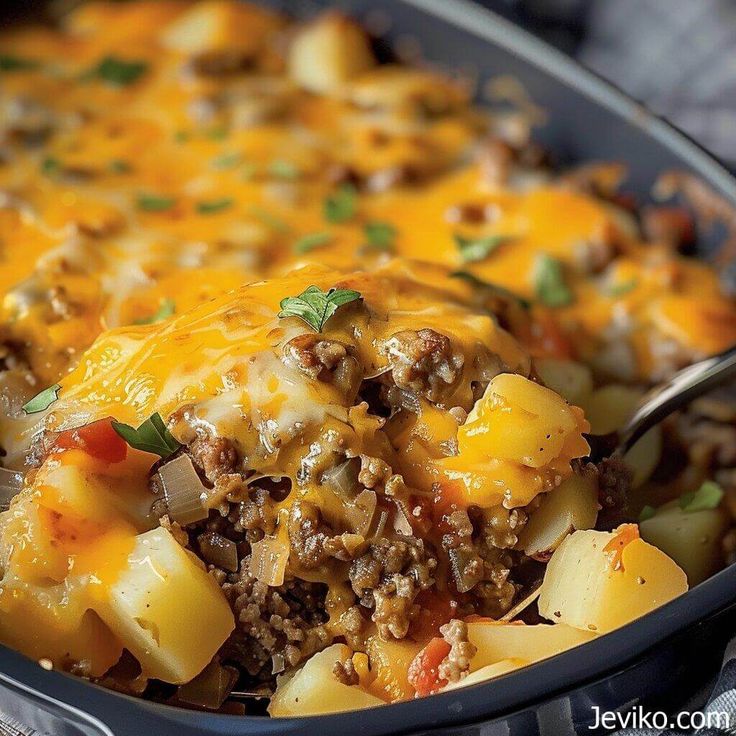 a casserole dish with meat, potatoes and cheese