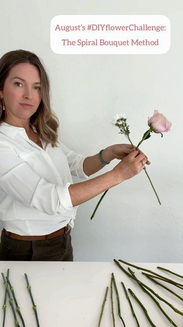 a woman is holding flowers in her hands