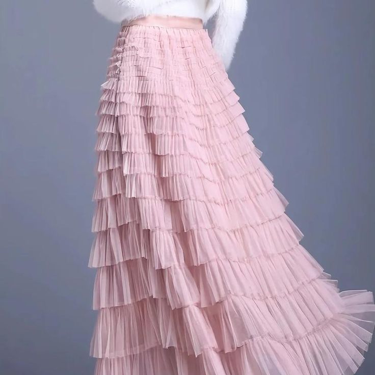 Discover the Charm of Elegance Step into a world of grace and style with our Elegant Spring/Summer Tulle Skirt. Designed for the modern woman who appreciates a blend of casual sophistication and timeless elegance, this skirt is perfect for a variety of occasions. Whether you're attending a casual gathering or dressing up for a more formal event, this skirt will elevate your wardrobe with its chic and versatile design. Product Features Material: High-quality polyester and voile blend for durability and a soft feel Style: Casual yet chic, with a solid pattern that pairs easily with any top Elasticity: Slight stretch to fit your body comfortably Season: Ideal for spring and summer wear Waistline: Empire cut to accentuate your figure Fit Type: Regular fit ensuring freedom of movement Silhouett Feminine Long Maxi Skirt For Evening, Feminine Evening Long Maxi Skirt, Elegant Spring Flared Maxi Skirt, Feminine Summer Evening Skirt, Elegant Skirt With Ruffles, Spring Pleated Flared Maxi Skirt, Elegant Tiered Maxi Skirt For Spring, Feminine Evening Maxi Skirt With Lining, Feminine Evening Maxi Skirt