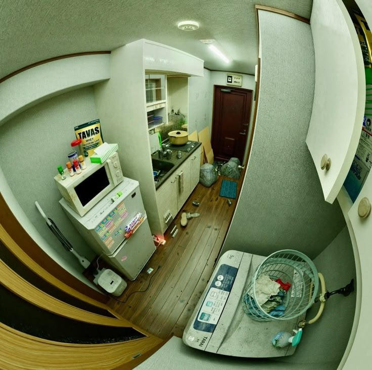 an aerial view of a kitchen and living room from the top floor looking down at it's appliances