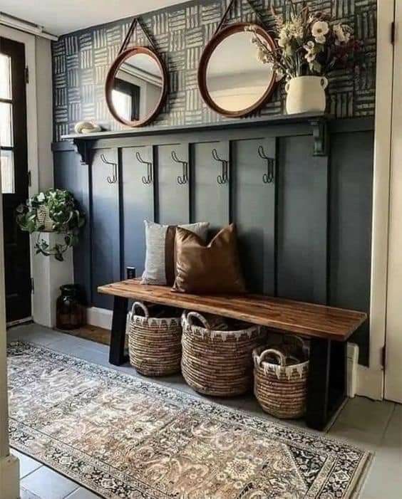 a bench with baskets and mirrors on the wall