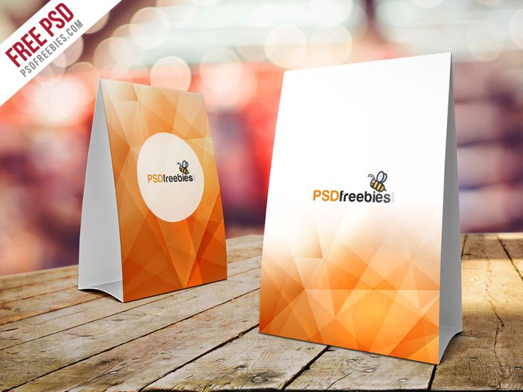 two paper bags with the logo pst freebies on them sitting on top of a wooden table