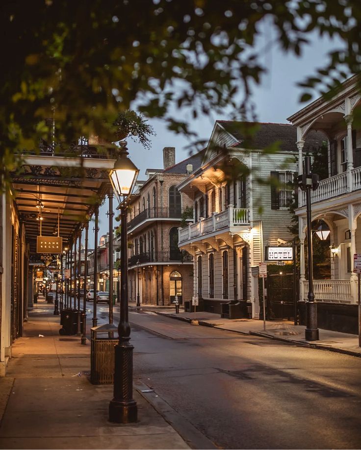 an empty city street at night with lights on