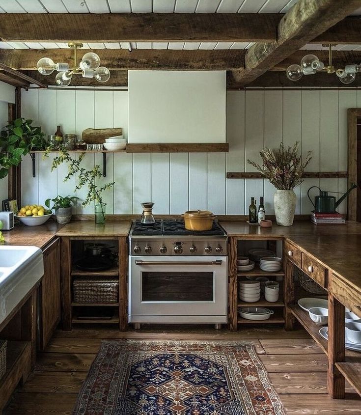 a kitchen with an oven, sink, and rug in the middle of the room