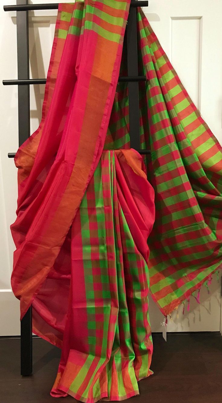 This is a light weight uppada soft silk saree in checks pattern. Pleats are in green and magenta checks, body and upper front chest drape is plain magenta and pallu is green and magenta checks. It has a very subtle thin zari border. Comes with a plain unstitched blouse piece with subtle zari borders. * Colour may vary slightly due to lighting  *No falls or pico done *All sales are final *Dry clean only *Handloom products may have some irregularities unlike power loom products Pink Silk Saree, Checks Pattern, Rani Pink, Visual Language, Magenta Pink, Soft Silk Sarees, Pink Silk, Power Loom, Check Pattern