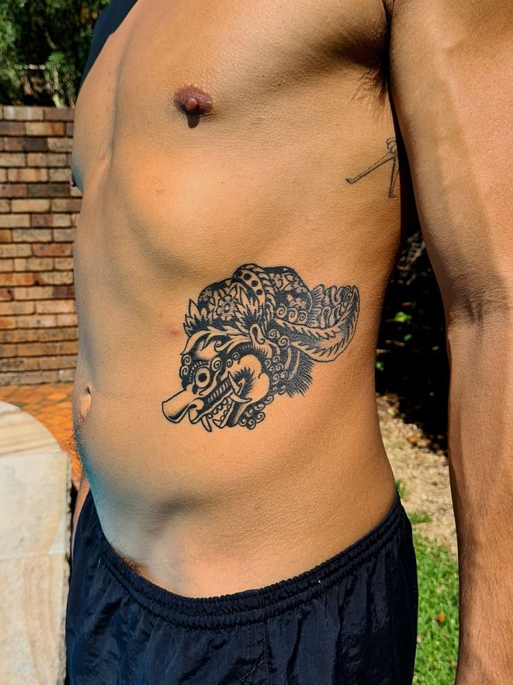 a man with a wolf tattoo on his stomach