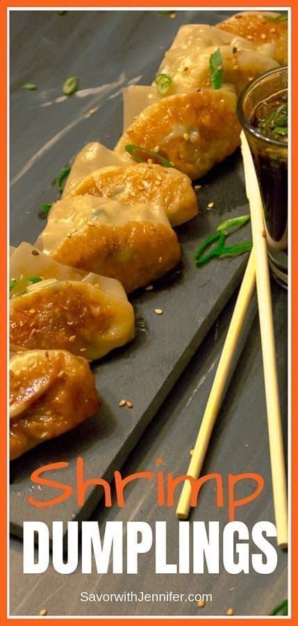 shrimp dumplings with dipping sauce and chopsticks on a slate platter, ready to be eaten