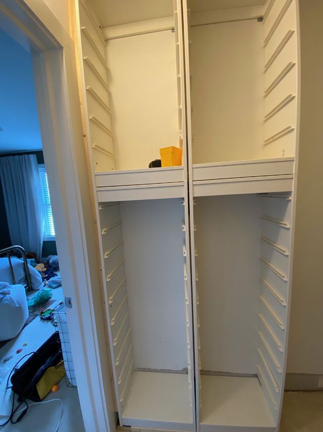 two empty white shelves in a room