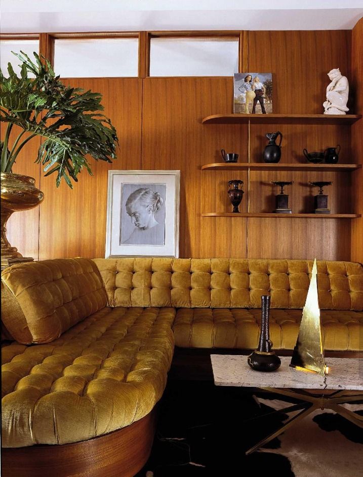 a living room filled with furniture and a potted plant on top of a table