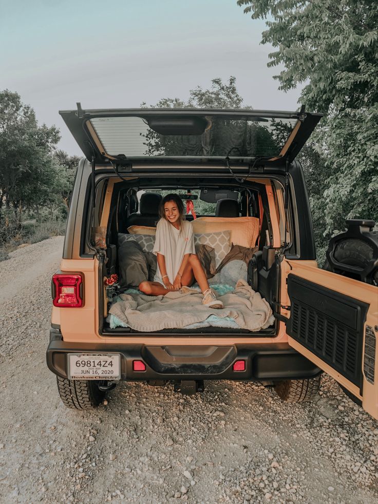 a person sitting in the back of a truck