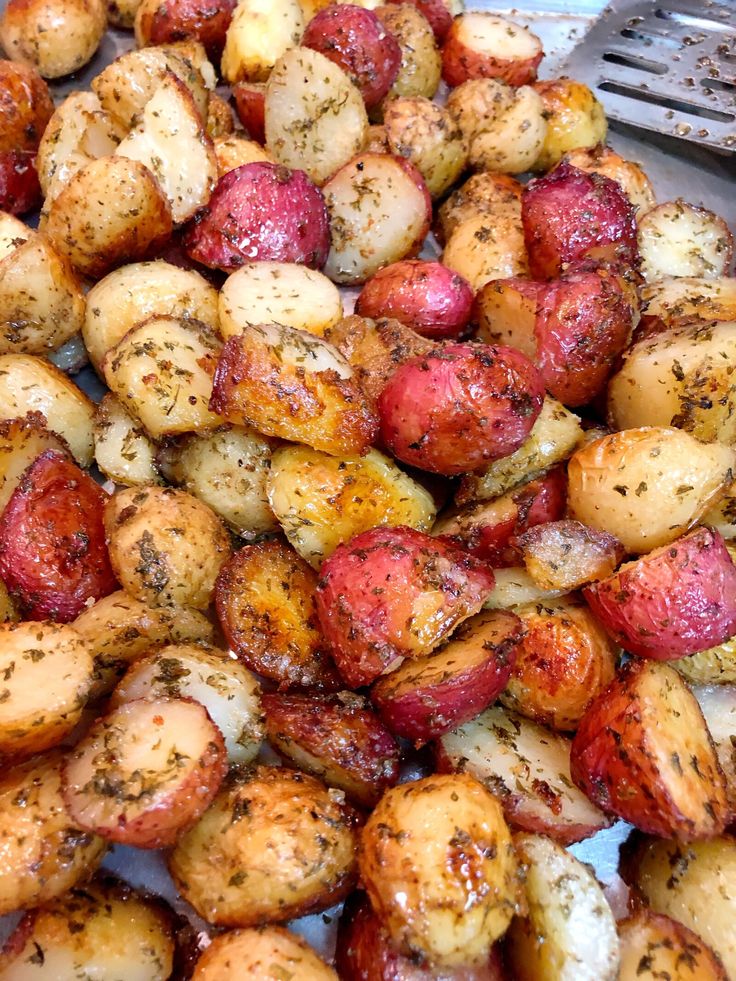 roasted potatoes with herbs and seasoning on them