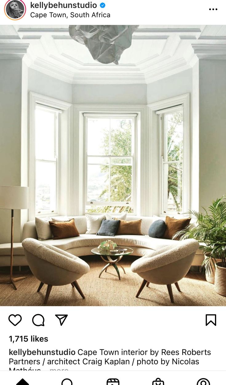 a living room filled with furniture and windows