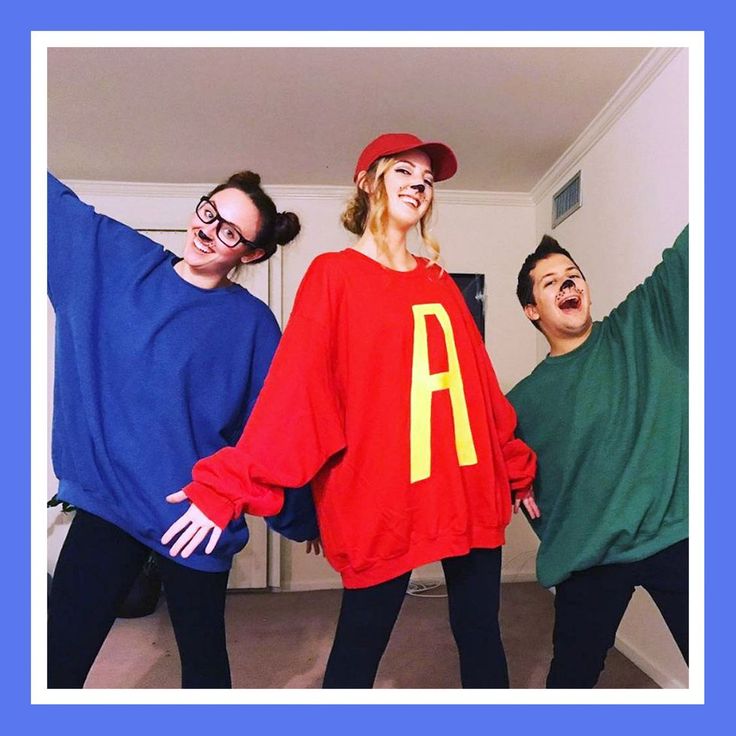 three people dressed up in costumes posing for a photo with the letter a on their shirt