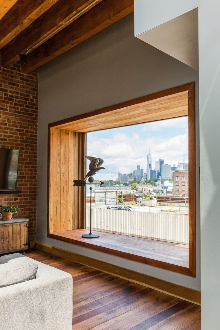 a living room with wooden floors and brick walls