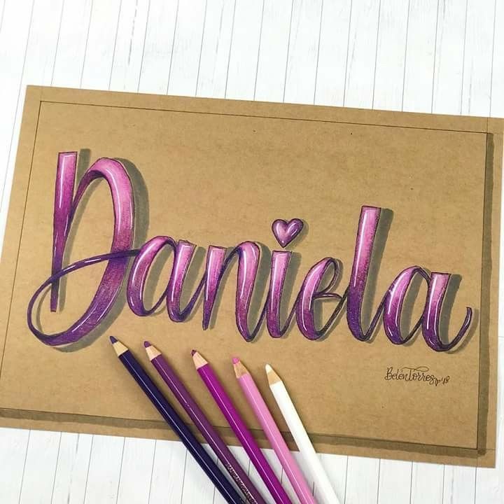 some pencils are laying on top of a piece of paper with the word danielle written in it