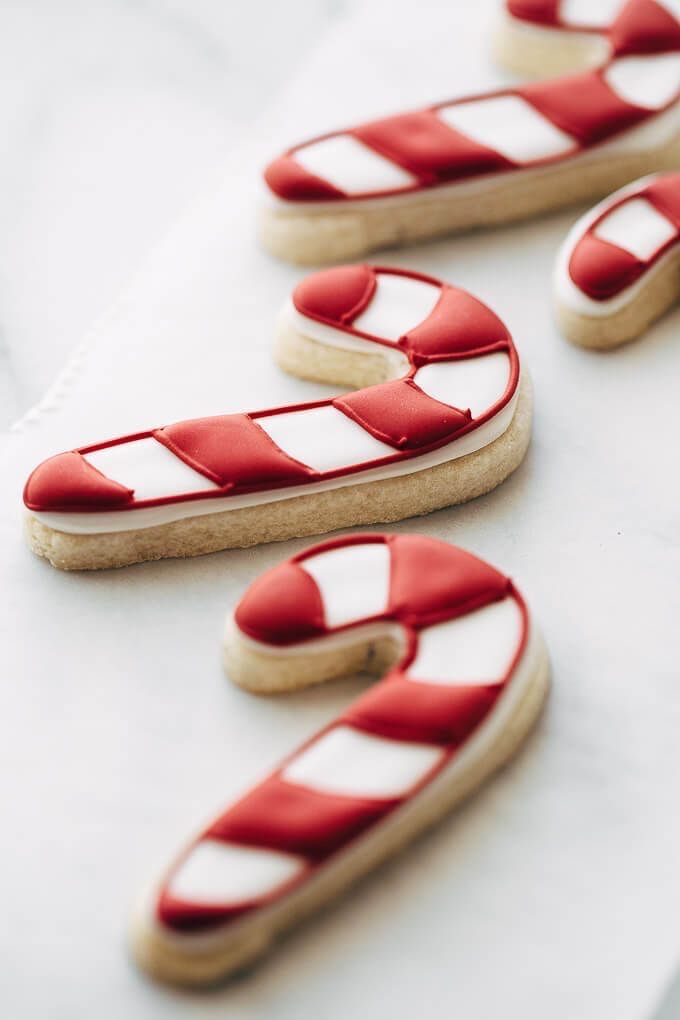 cookies decorated with red and white stripes on a table