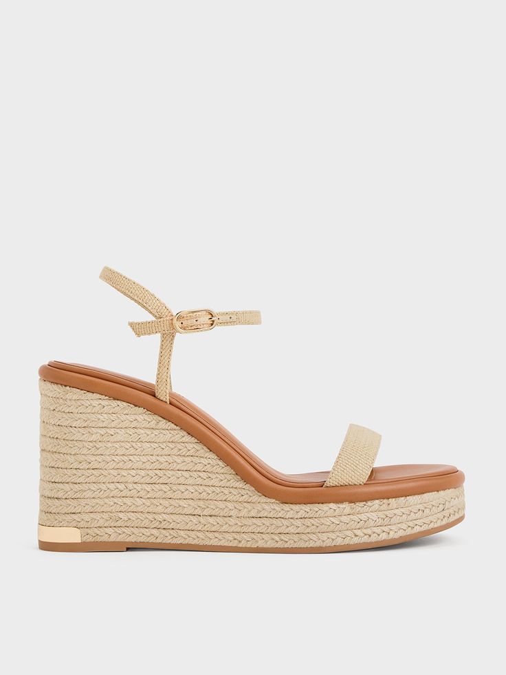 During summertime, no outfit is complete without a pair of espadrilles. Incorporate these woven wedges into your warm-weather wardrobe to ensure you are always stylish and prepared for a seaside stroll or tropical getaway. With their breathable open-toed design, your feet will stay cool and comfortable all day long. Plus, the 9.5cm wedge soles not only add tactile appeal but also offer stability and a height boost. Beige Straw Espadrilles For Summer Outings, Beige Straw Espadrilles For Vacation, Beige Straw Espadrilles For Beach Season, Straw Sandals With Cork-bed Midsoles For Summer, Chic Sandals With Cork-bed Midsoles, Chic Straw Sandals With Cork-bed Midsoles, Beach Straw Wedge Sandals With Cork-bed Midsoles, Vacation Espadrille Wedge Sandals With Textured Sole, Open Toe Straw Espadrilles With Woven Detail