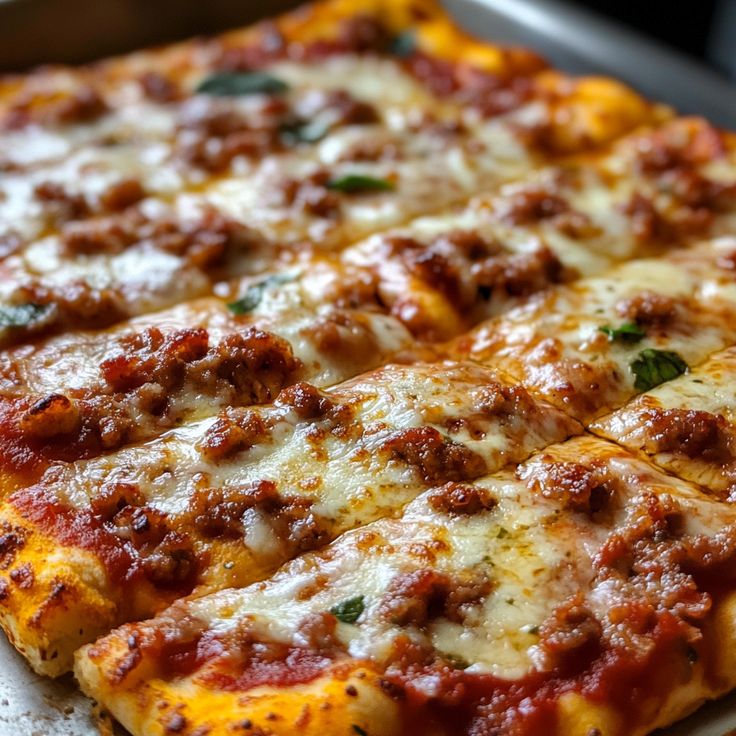 a close up of a pizza with cheese and meat toppings on the top slice