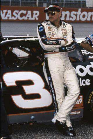 a man standing in front of a race car