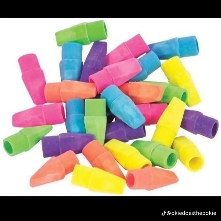 many different colored plastic tubes are stacked on top of each other