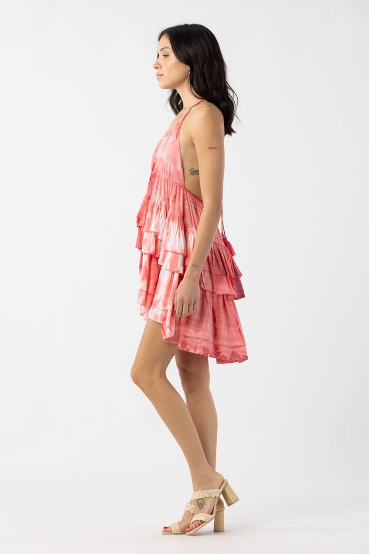 The Shane Mini Dress is a flirty silhouette and features a plunging V neckline and self tie closure to compliment the elegant open back silhouette creating a perfect fit. You won’t be able to resist this layered mini dress. Details: 100% Rayon Hand Wash & Lay flat to dry Features: Plunging v neck with tie closure, Elastic waistband for adjustable fit Flirty Backless Vacation Dress, Flowy Tie Back Mini Dress, Flowy Mini Dress With Tie Back, Flowy Backless Sundress, Sundress Style Backless Mini Dress For Brunch, Tiered Beachwear Dress For Day Out, Flowy Backless Flirty Mini Dress, Flirty Flowy Backless Mini Dress, Flowy Backless Mini Dress